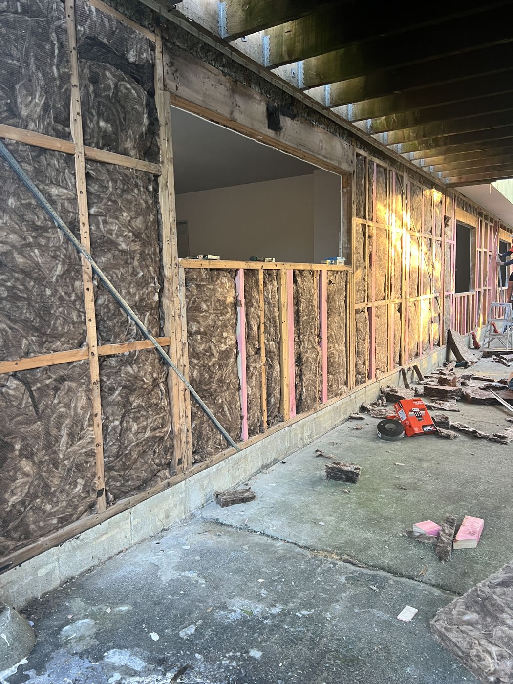 New framing and insulation installed alongside original studs