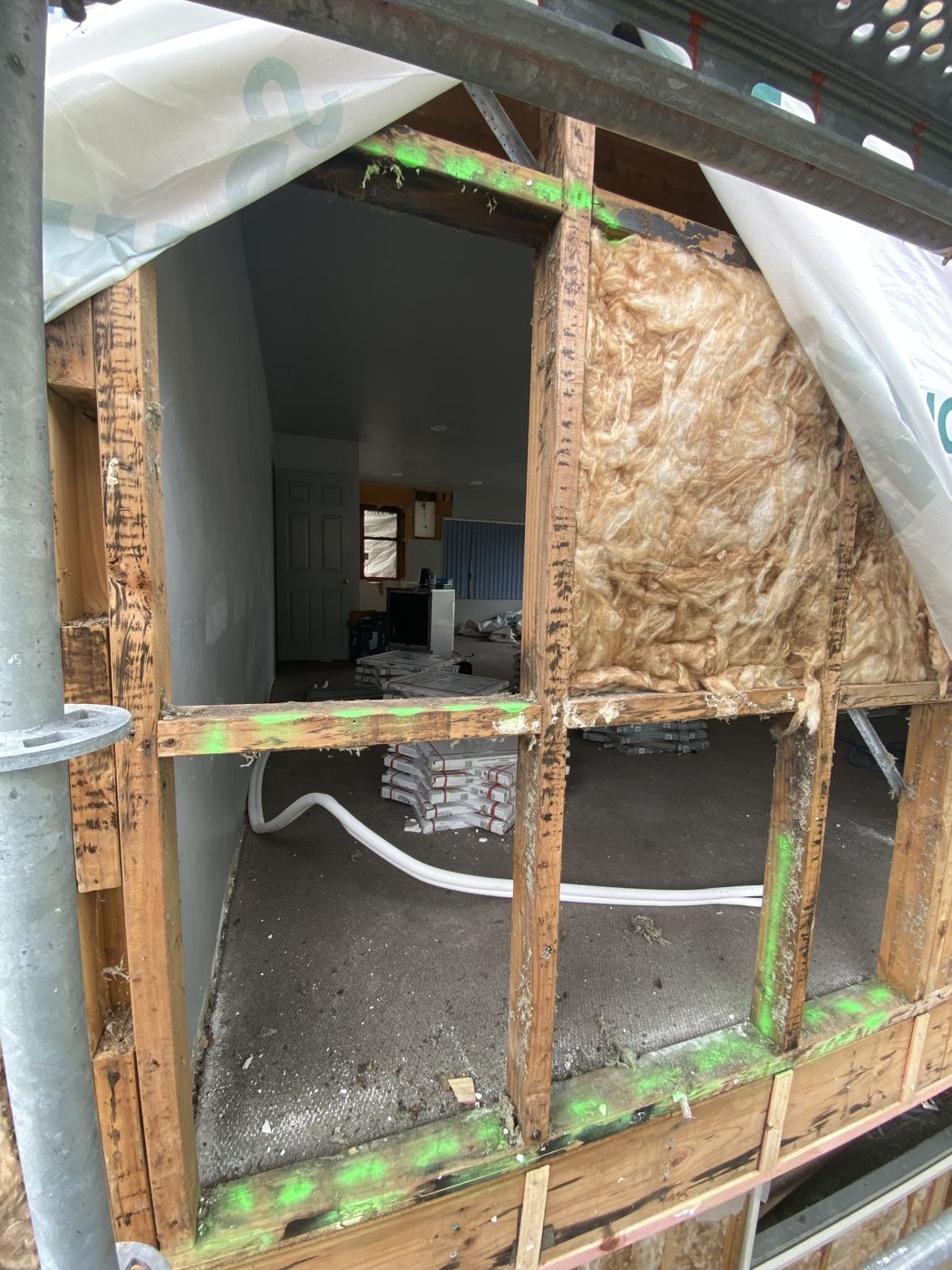 Framing with damaged timber marked for replacement
