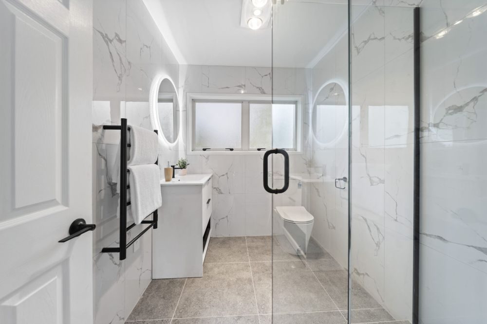 Reclad project: marble-look tiled bathroom with walk-in shower